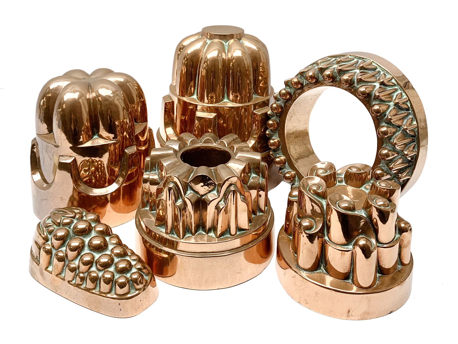 Six Victorian copper jelly moulds, five examples of castle type form, one example modelled as a bunch of grapes, largest H21cm