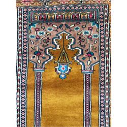 Angle-poise lamp and an Islamic prayer mat
