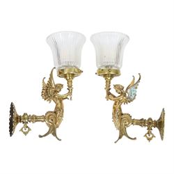 Pair of Victorian style wall sconces, each modelled as a caryatid supporting a single light fitting in one raised arm, with tapering and fluted clear glass shade, approximately H31cm D21cm