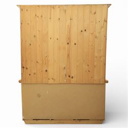 Late 20th century pine and white painted dresser, the upper section with three shelves and boarded back, upon a base with three drawers with knob handles and three panelled cupboard doors, on a raised sled base