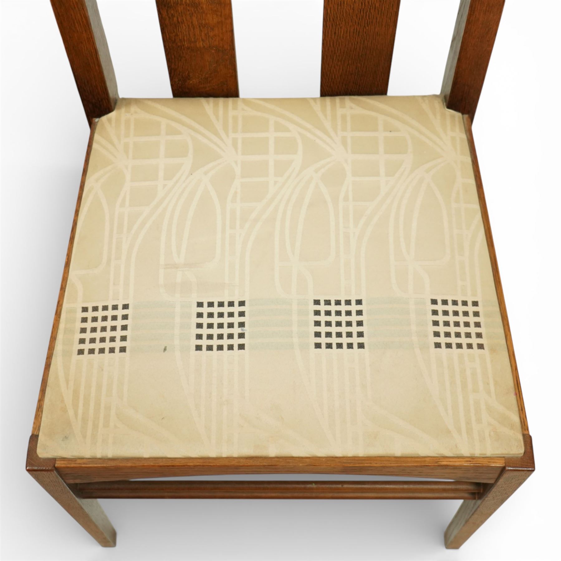 Late 20th century Mackintosh design oak 'Argyle' dining chairs, with elongated backs featuring pierced shaped top rails and twin vertical splats, upholstered seats, raised on square legs with stretchers