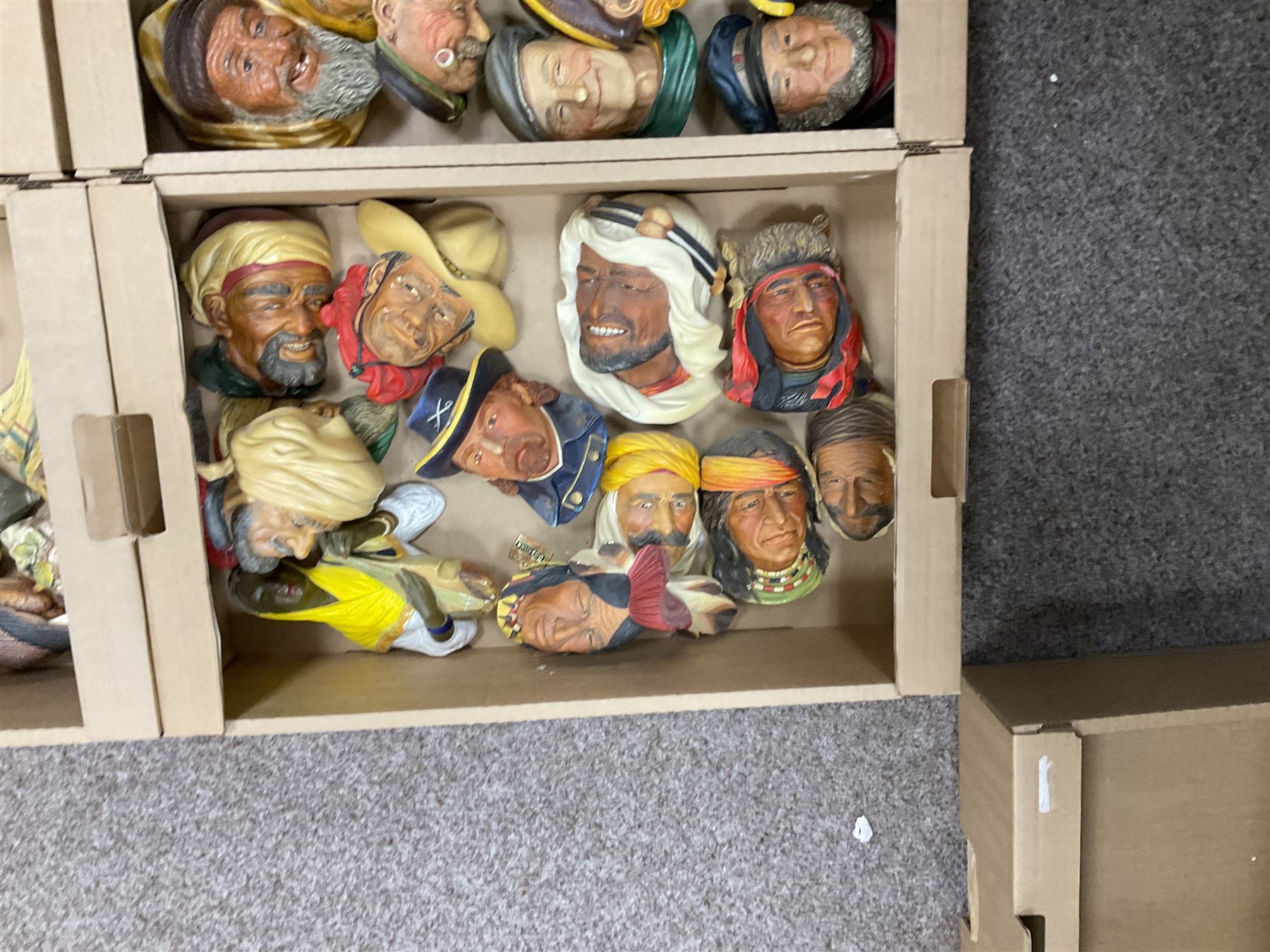 Large collection of Bossons plaster wall-masks, including including fisher man, cowboys, native Americans, etc, in four boxes 
