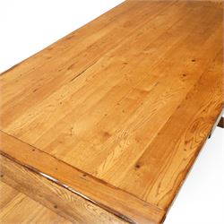 Late 20th century light oak extending refectory table, in the manner of Titchmarsh & Goodwin, rectangular plank top with cleated ends and two draw leaves extending to 260cm, supported on turned end supports united by a stretcher, raised on block feet