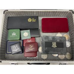 The Royal Mint United Kingdom 1977 silver proof two coin set, Queen Elizabeth II 2002 silver proof three coin set, comprising Bailiwick of Jersey, Bailiwick of Guernsey, and Alderney five pound coins, 'First Coinage of the British Virgin Islands' proof set, 1997 1/10 ounce fine silver Britannia, two King George V 1935 'Rocking Horse' crowns, various Isle of Man commemorative crowns, etc., house in a hard shell carry case