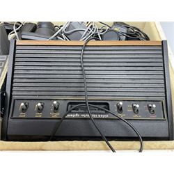 Atari 2600 'Woody' console with various joysticks and controllers etc, and a quantity of game cassettes to include 'Outlaw', 'Air Sea Seattle' and 'Codebreaker' etc housed in white painted wood case