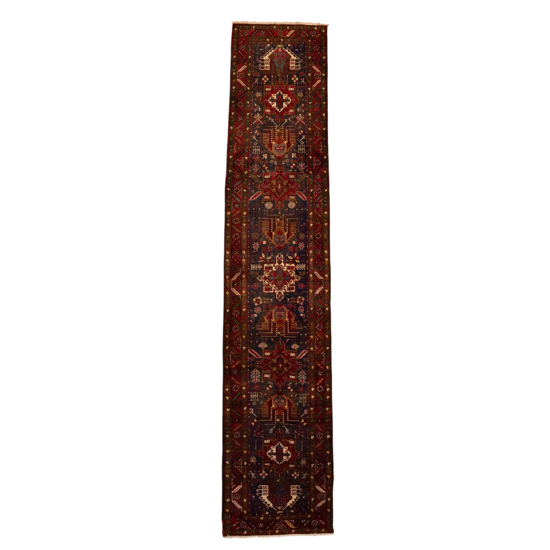 Large Northwestern Persian Hamadan hand-knotted runner, indigo field, with a column of bold geometric medallions and scattered stylized motifs within a madder border of angular rosettes and meandering vines 