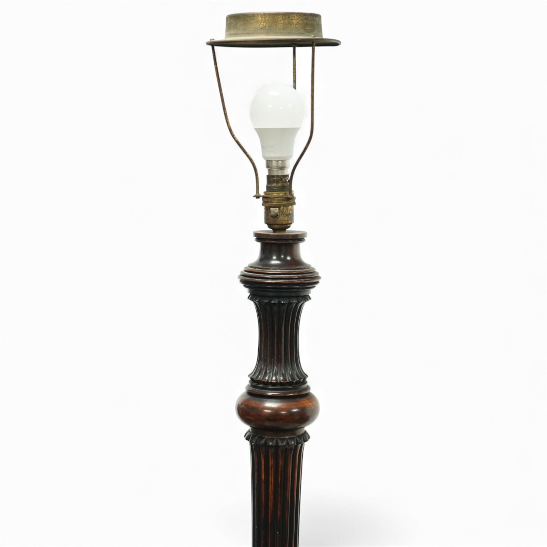 20th century mahogany standard lamp, with fluted tapering column above a turned and moulded circular base, standing on three short bracket supports