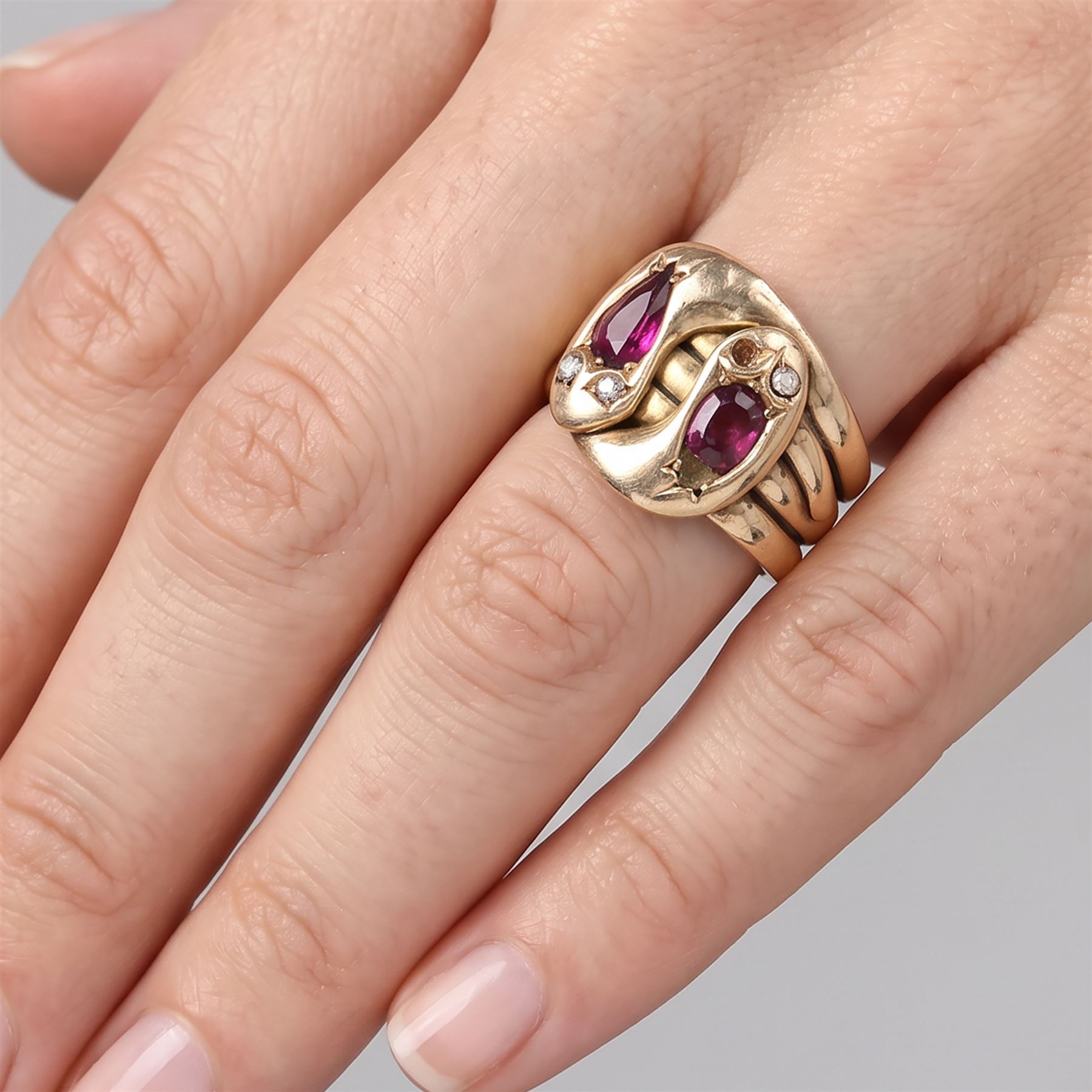 Edwardian 9ct rose gold garnet and diamond double coiled snake ring, set with rose cut diamonds and pear cut garnet, Chester 1907