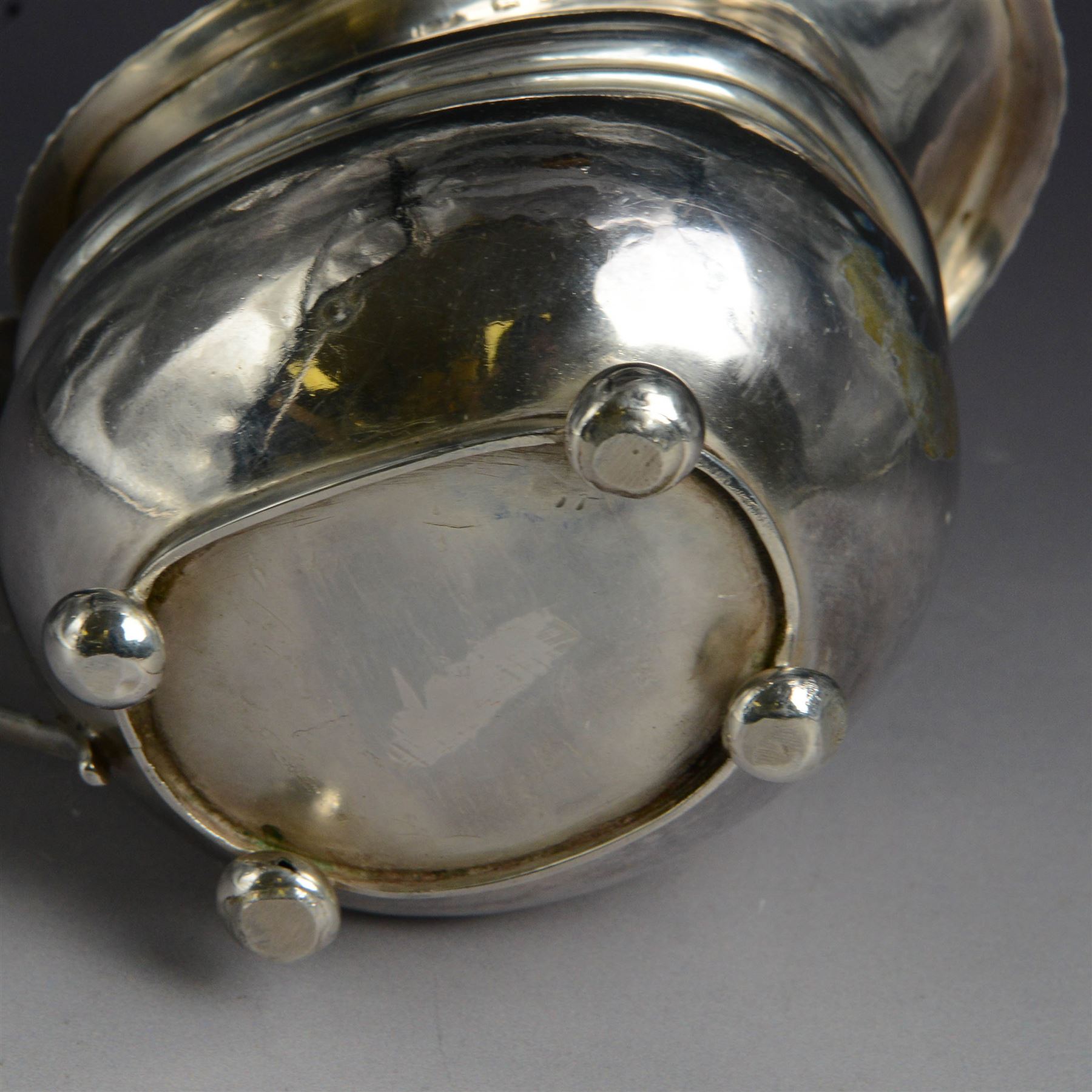 George III silver milk jug, of oval form with oblique gadrooned rim and acanthus leaf capped handle, upon four bun feet, hallmarked London 1819, maker's mark worn and indistinct, H10cm