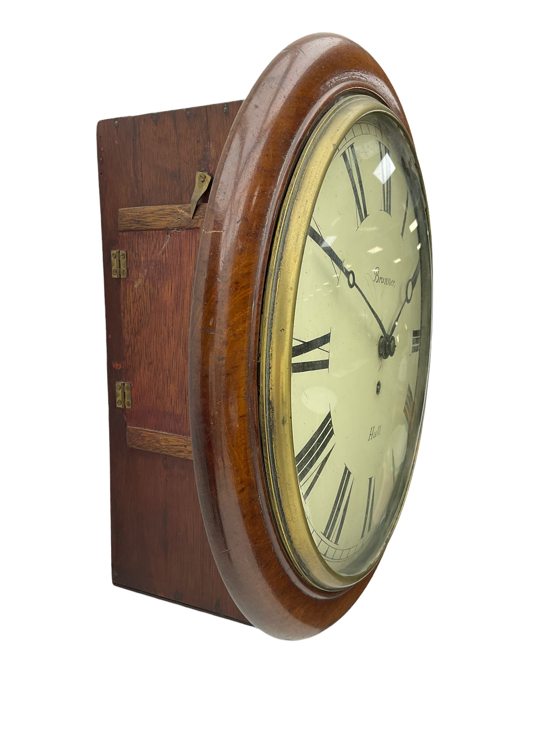 A late 19th century 8-day wall clock with a 15” mahogany bezel and 12” painted convex dial with a cast brass bezel, Roman numerals, minute track and matching steel moon hands, dial inscribed “Brunner, Hull” with a single train fusee movement, anchor escapement, rectangular movement plates with chamfered shoulders, case with two side doors and pendulum adjustment door to the curved base. With pendulum.  
****Engelbert Ignatius Brunner from Baden (Germany)  worked from Queen Street Hull . c 1886-1907.

