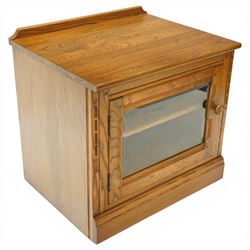 Ercol - elm media cabinet of small proportions, fitted with glazed door enclosing single shelf, on skirted base