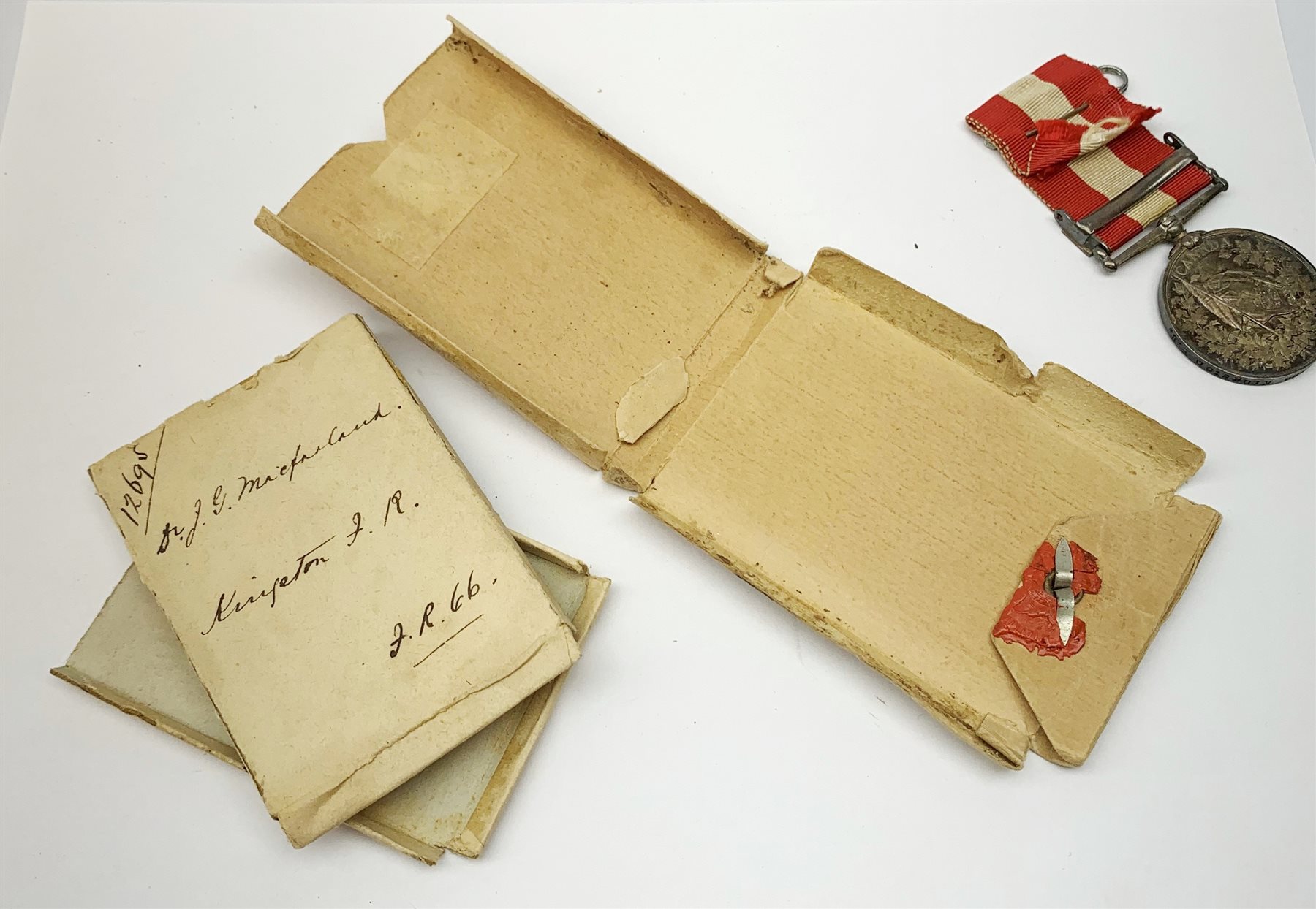 Victorian Canada General Service Medal with Fenian Raid 1866 clasp awarded to Dr. J.G. MacFarland Kingston F.B. in original issue box with outer packaging
