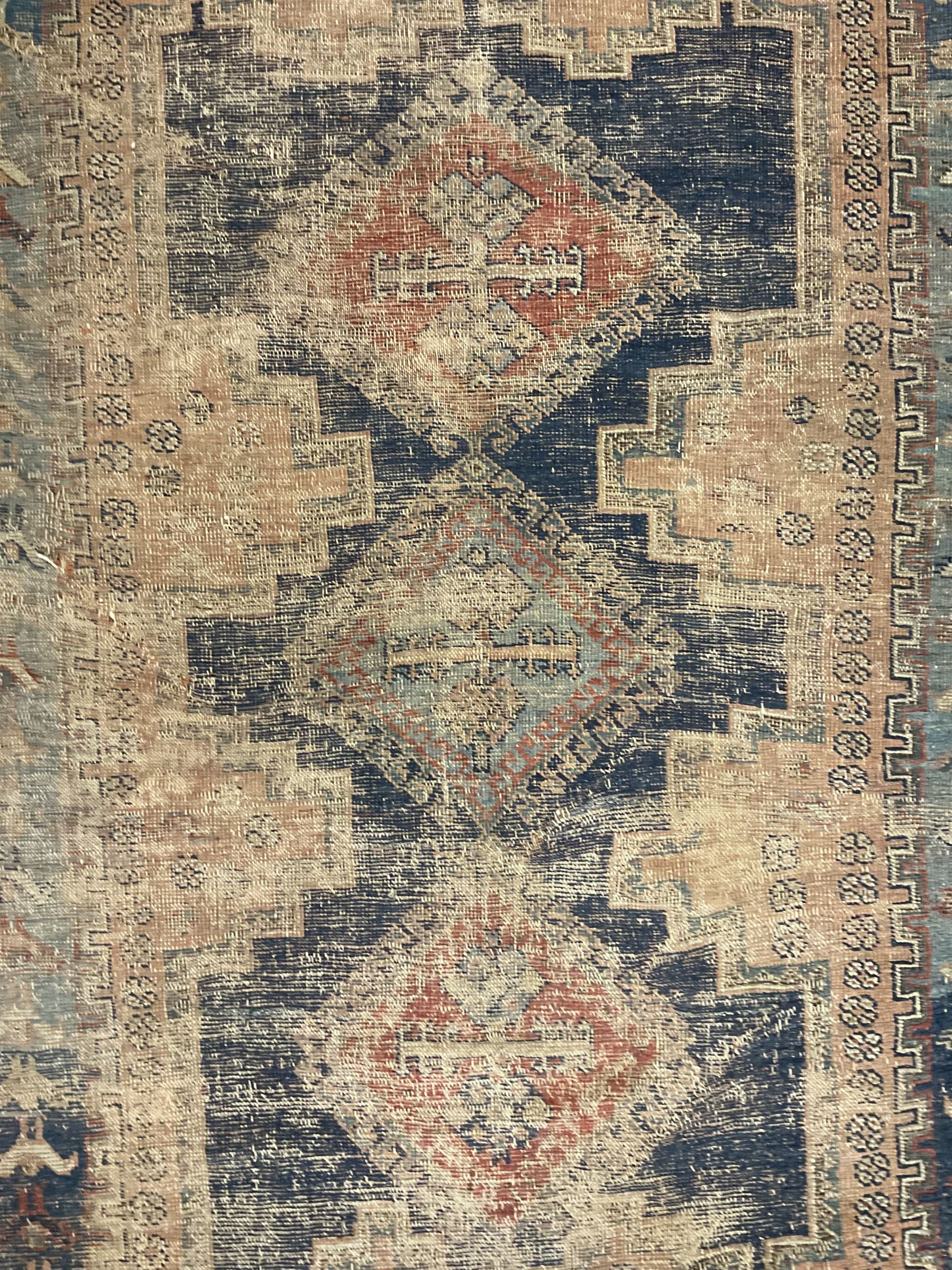 Antique Caucasian rug, indigo ground field decorated with three lozenge medallions within borders of stylised bird and flower head motifs