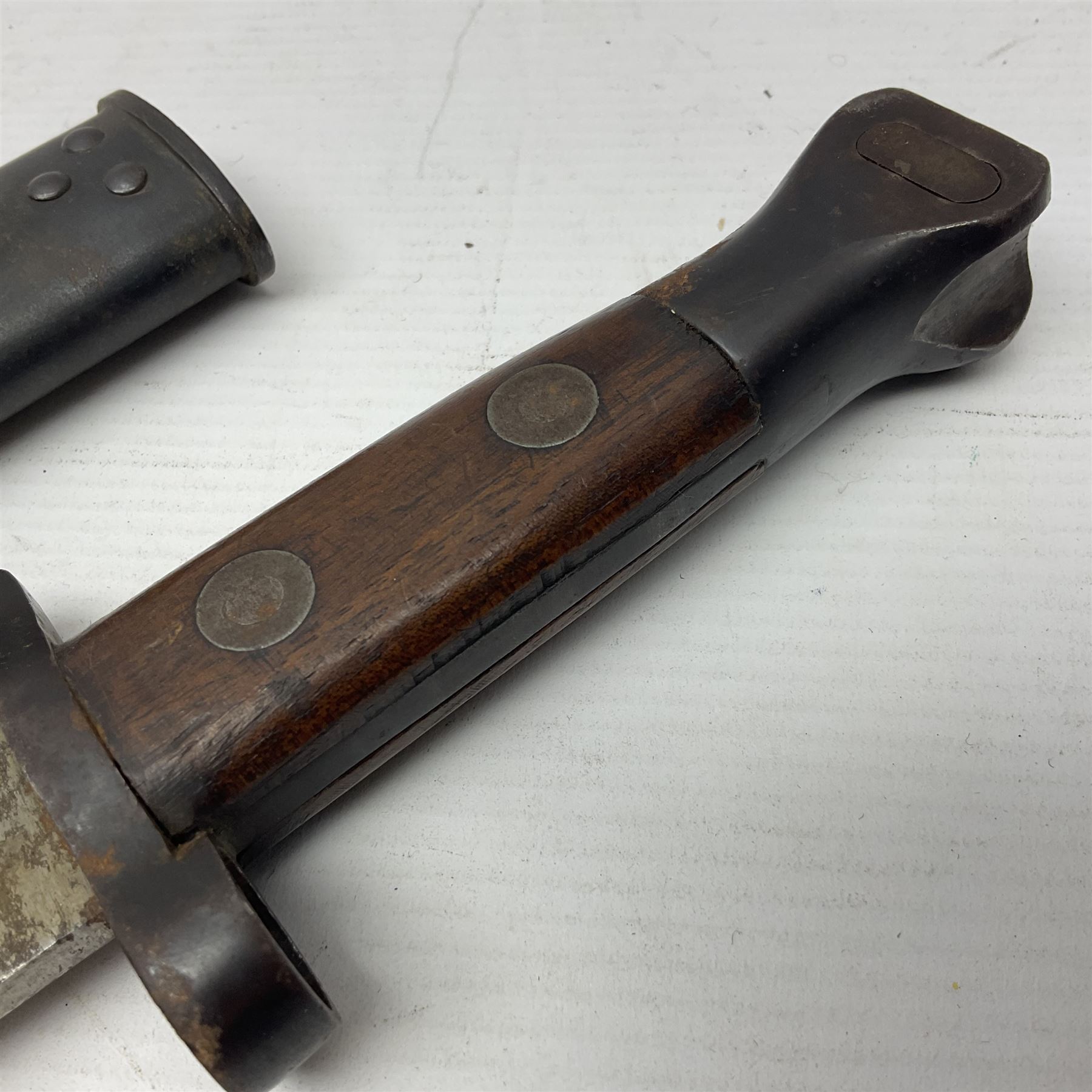 British Pattern 1888 knife bayonet, the 30.5cm double edged blade with raised central medial ridge; in leather covered scabbard L40.5cm overall