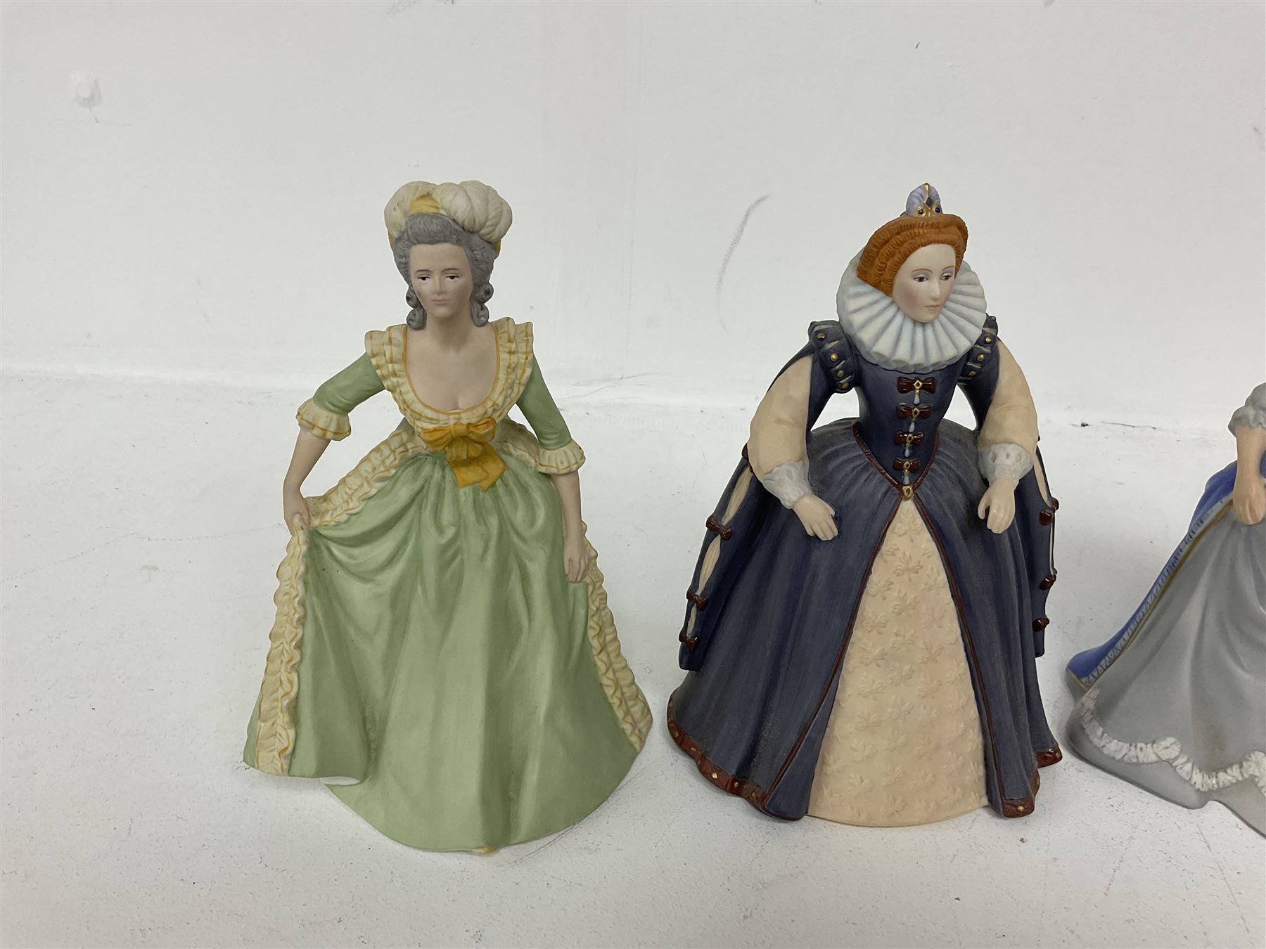 Four limited edition Franklin Mint figures of queens comprising Elizabeth I, Isabella of Spain, Catherine the Great and Marie Antoinette