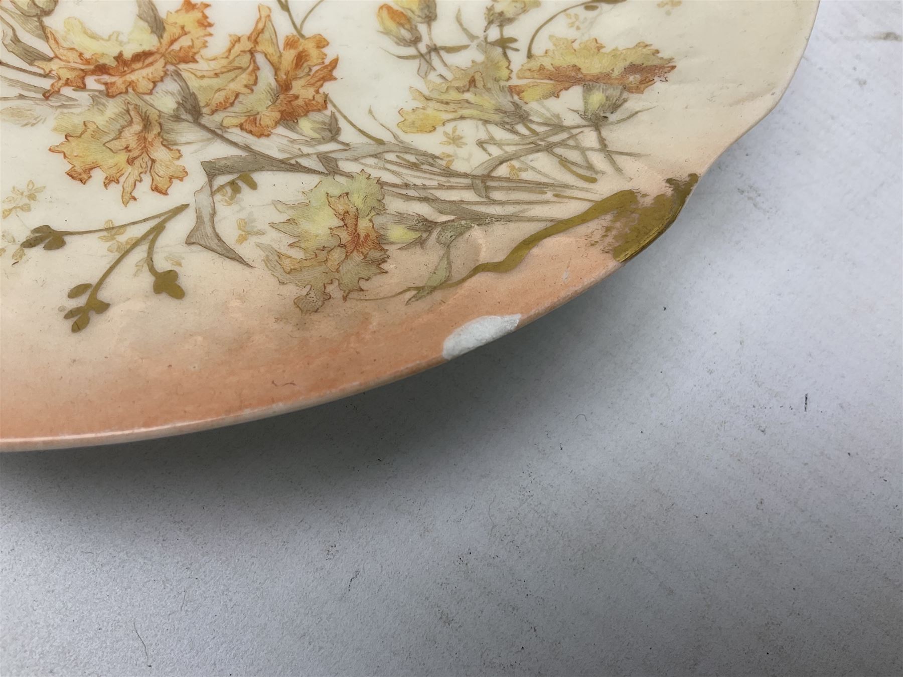 Early 20th century Limoges part tea service, decorated with floral sprays and gilt on merging peach and white ground, comprising six teacups, twelve side plates, six smaller plates, milk jug, open sucrier, slop bowl and two cake plates, many marked R Delinieres Limoges D&C France to base