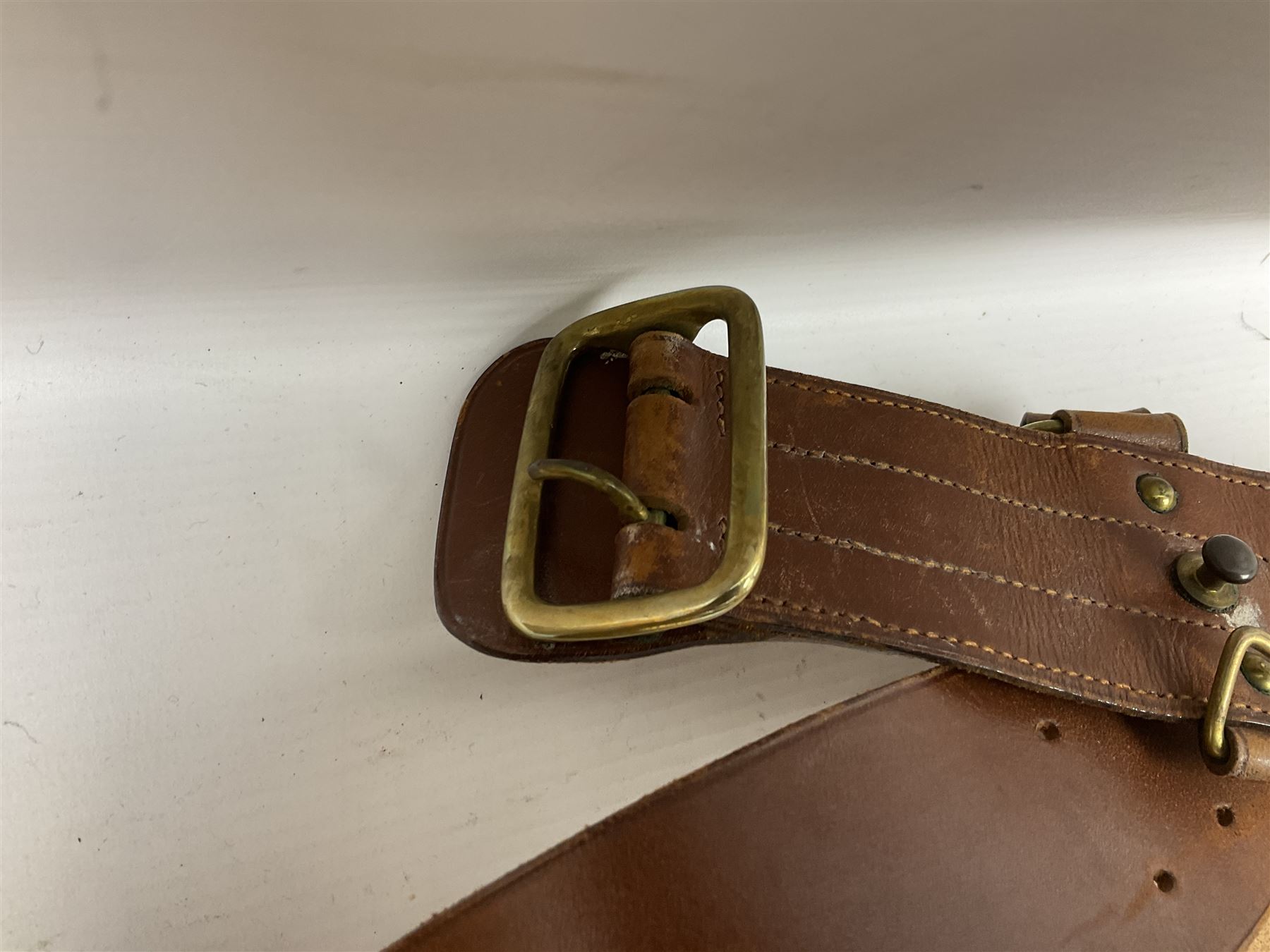 British Army General Staff officer's peaked cap by Herbert Johnson London in Moss Bros. delivery box; two officer's Sam Browne leather belts; leather pistol holster and sword hanger; pair of leather gloves and pair of spurs