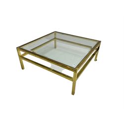 Brass framed coffee table fitted with bevelled glass top and undertier  