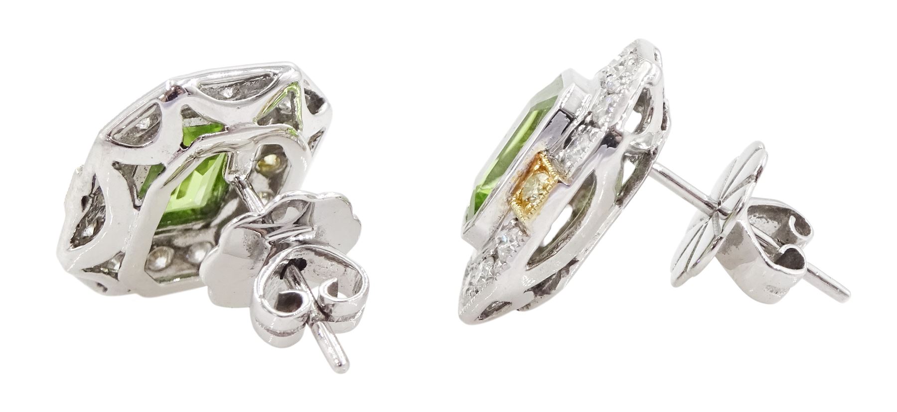 Pair of 18ct white and yellow gold emerald cut peridot and milgrain set round brilliant cut diamond stud earrings, total peridot weight 3.11 carat, total diamond weight 0.70 carat, with World Gemological Institute report