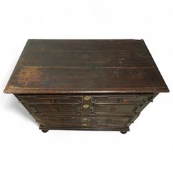 Late 17th-century oak chest, rectangular top above four graduated drawers with geometric panel mouldings, in two sections, supported on bun feet 
