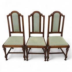 Victorian mahogany extending dining table, rectangular top with chamfered corners above a plain frieze raised on turned reeded legs with castors and two additional leaves, 197cm fully extended, and a set of six early 20th century oak upholstered chairs with drop-in seats, arched panelled back splat and close studded border on turned front legs joined by stretchers, 47x41x109cm 