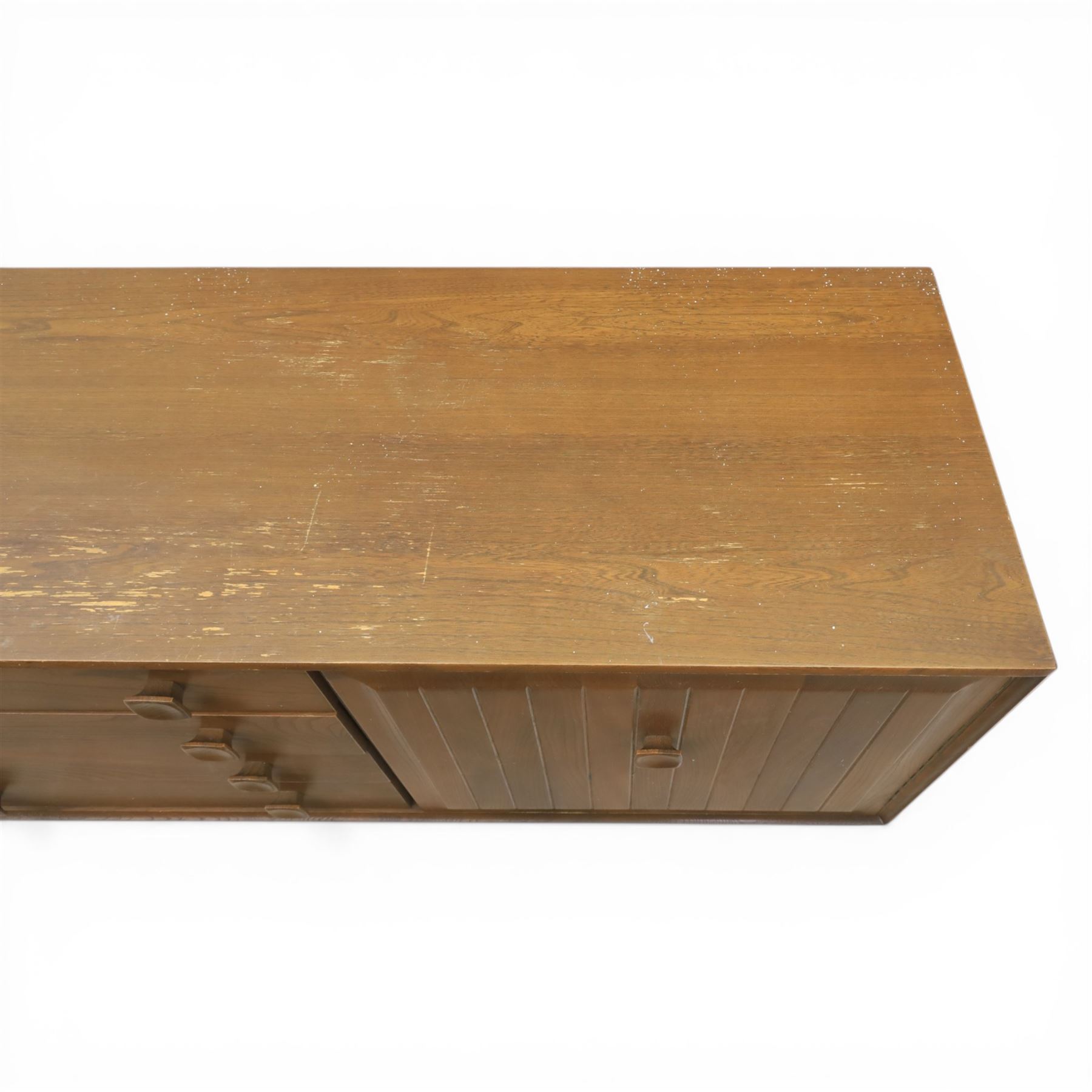 Ensign - Mid-20th century elm sideboard, with a central bank of four drawers, flanked by cupboard doors, raised on tapering supports, labelled Ensign Bristow & Townsend Ltd