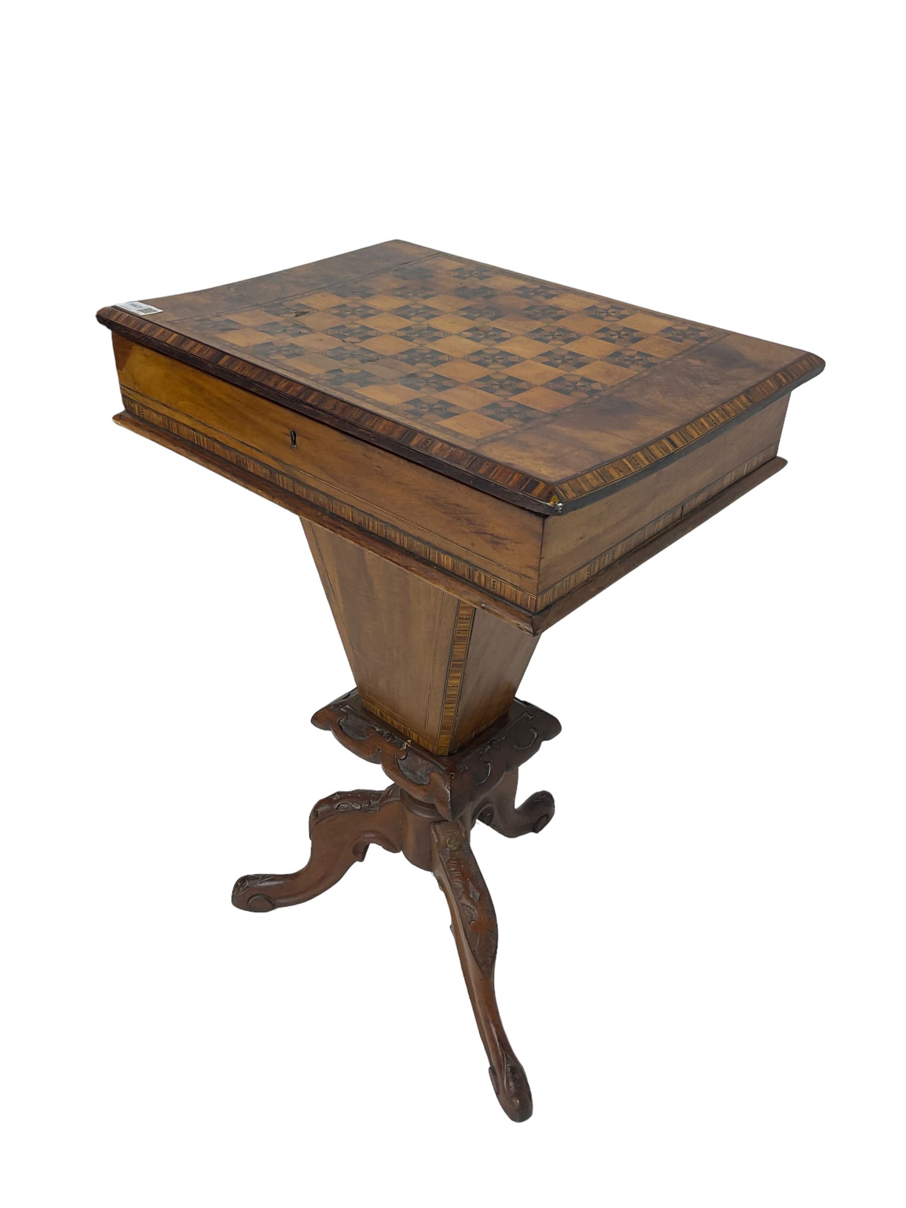 Victorian walnut work table, the rectangular hinged top inlaid with a chessboard design, canted edge with alternating ebony and satinwood inlays, concealing fitted interior, banded and strung frieze over tapering column well, collar carved with foliate decoration, on a cabriole tripod base