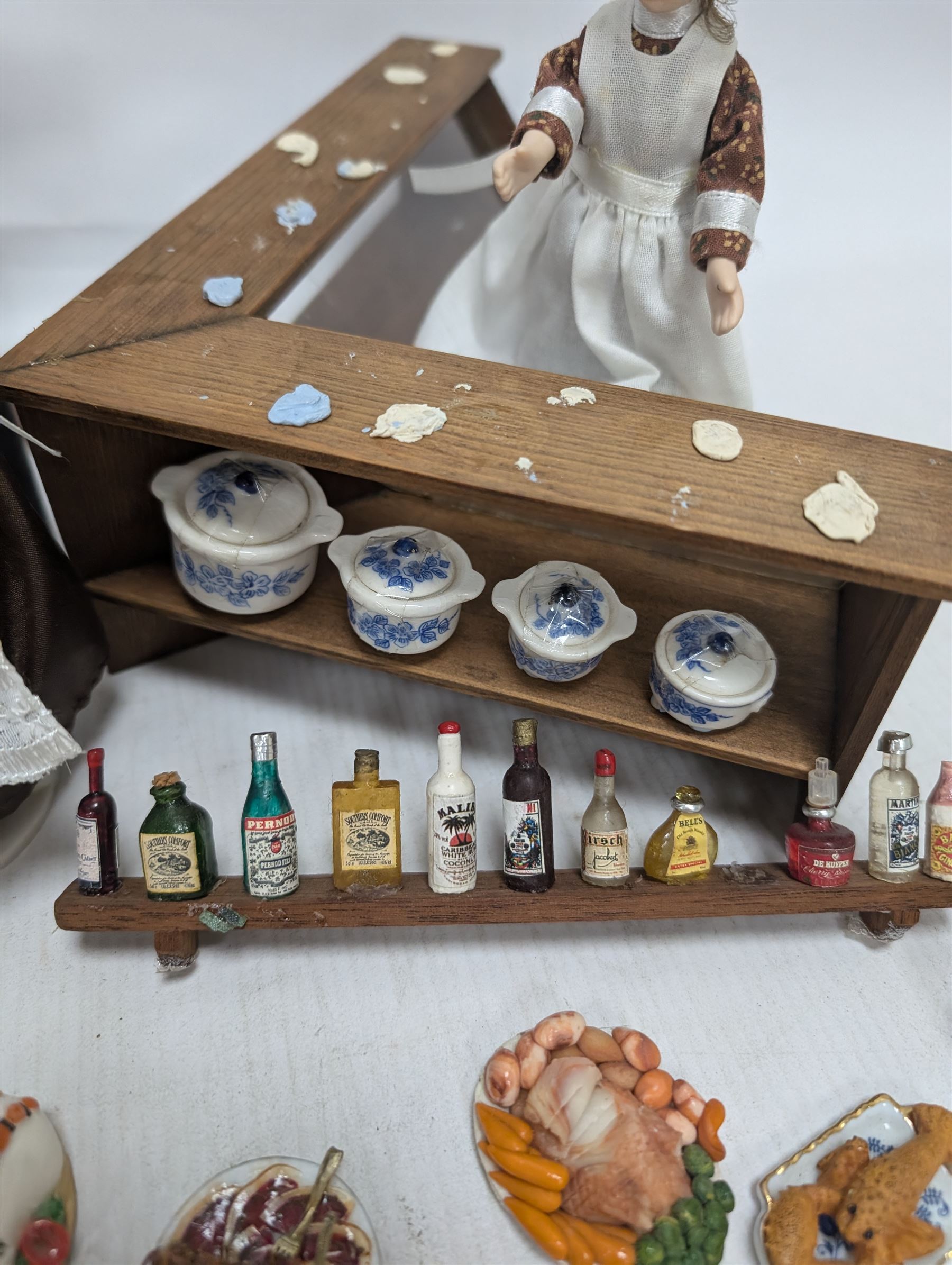 Victorian and later style dolls house kitchen furniture, including countertop, dresser displaying copper pots and blue and white ceramics, baking table, oven, three figures and a collection of food and baking accessories