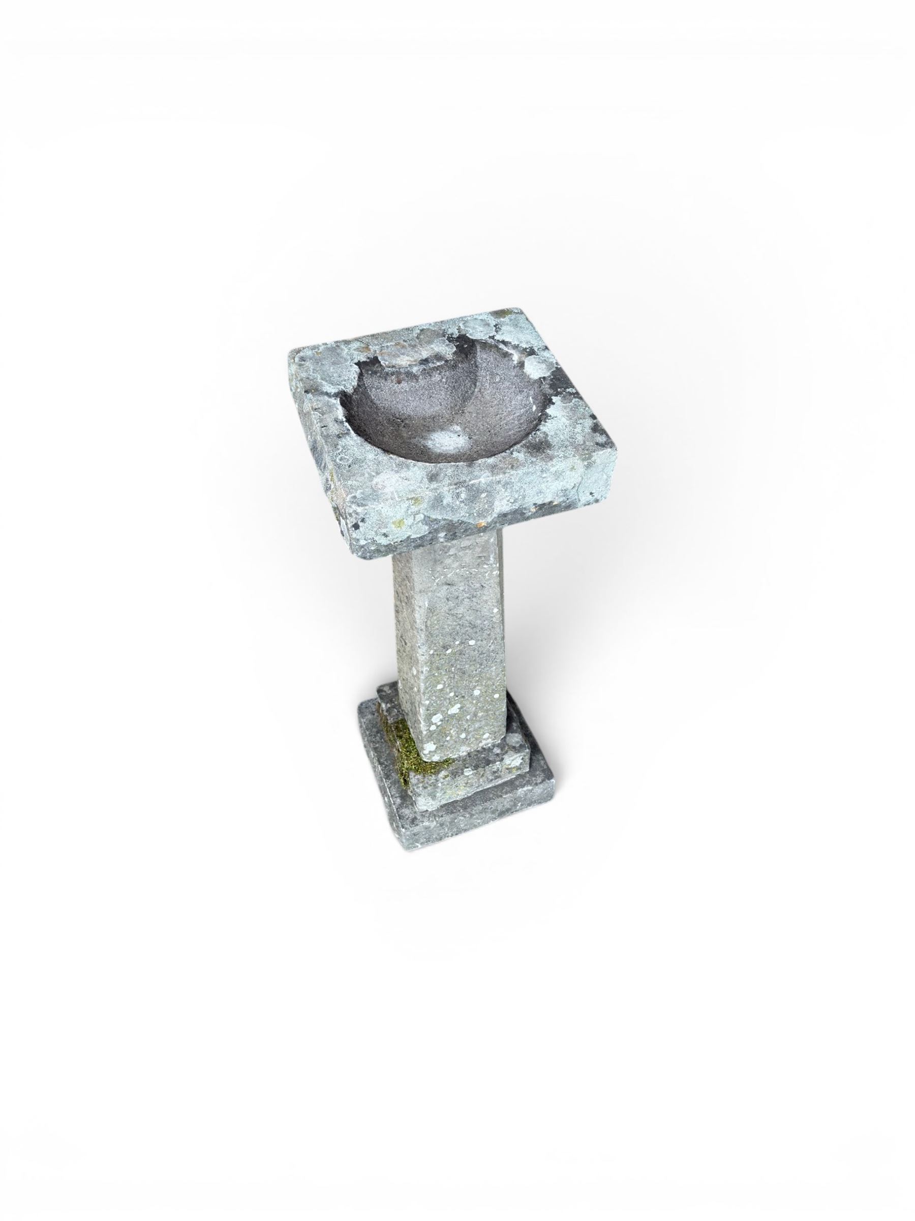 19th century weathered sandstone birdbath, formed in four sections, square top with carved shell bath, raised on tapering column with stepped base