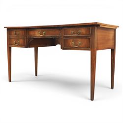 Regency style mahogany writing desk, serpentine front tooled green leather inset, slides to either side, central frieze drawer, flanked by a bank of two drawers, square tapering supports