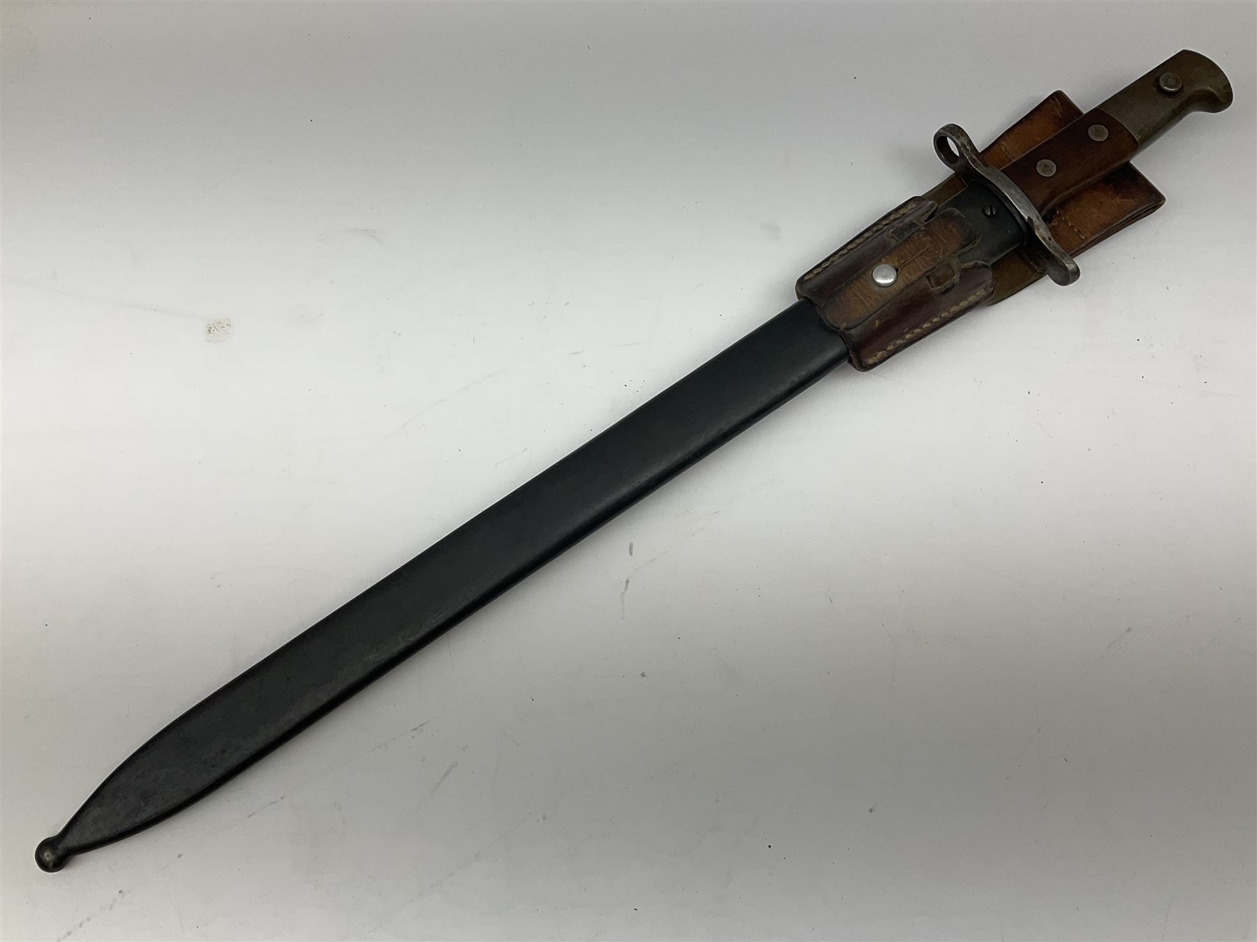 Swiss Schmidt-Rubin M1914 pioneer bayonet, with 48cm steel saw-back blade, the ricasso stamped, ''Waffenfabrik, Neuhausen'', the crosspiece stamped Swiss cross, steel scabbard, leather frog L64cm overall