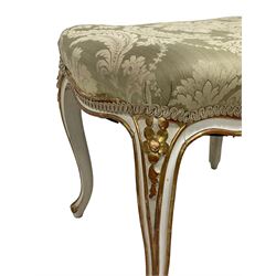 20th century French design parcel gilt and painted dressing table stool, upholstered in sage green damask fabric, shaped form on floral carved cabriole supports, with matching cushion 