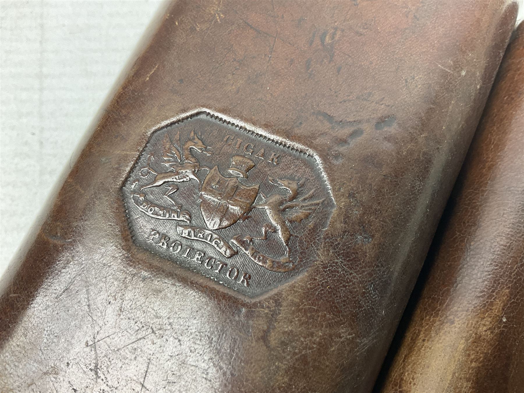 Victorian leather cigar protector with metal match striking plate on the end and internal spring to hold the cigars in place; expands for differing lengths of cigar, minimum L12.5cm; another similar leather cigar case marked Middlemore's Patent with attached vesta case and striker; three Bryant & Mays tin-late matchbox holders including 1935 Jubilee; and small box of matches (6)