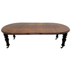 Victorian mahogany extending dining table, circular telescopic extending top with moulded edge, two additional leaves, on turned and lobe carved supports with brass and ceramic castors 