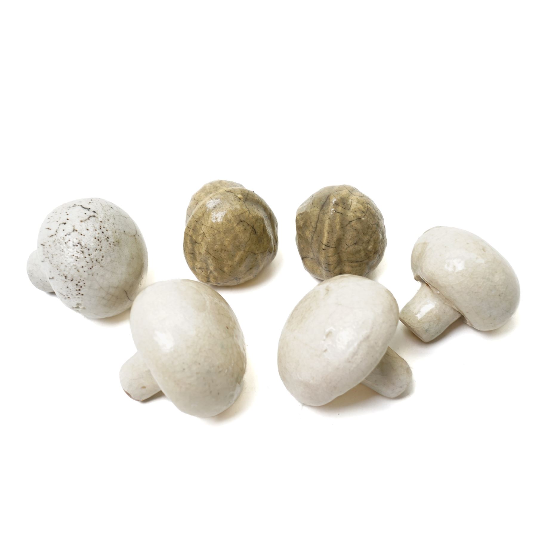 Collection of ceramic fruit and vegetables, including raku examples, comprising two walnuts, three mushrooms, one garlic bulb, a pear and an apple