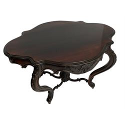 19th century Irish rosewood centre table, the shaped and moulded top over shaped apron carved with scrolled foliage, on serpentine supports carved with bell flowers, the supports united by anthemion carved finial and s-scroll x-framed stretchers