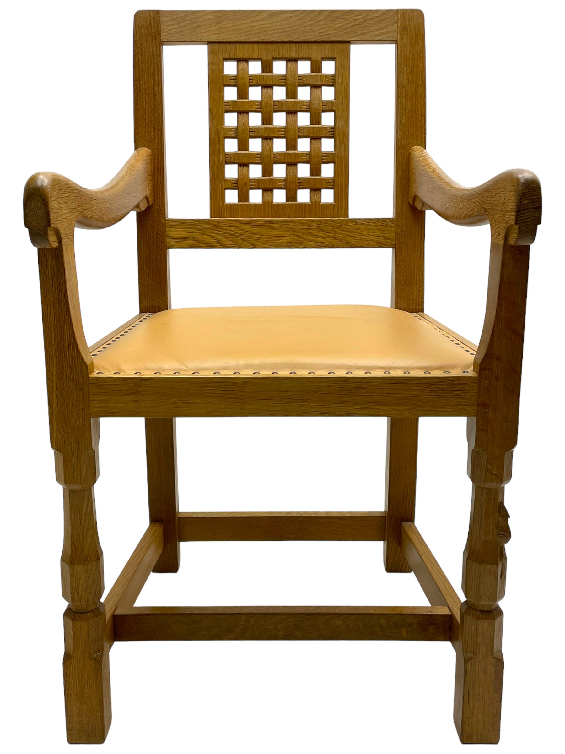 Mouseman - oak carver elbow chair, pierced and carved lattice back over leather upholstered seat with stud band, on octagonal supports united by plain stretchers, carved with mouse signature, by the workshop of Robert Thompson, Kilburn 