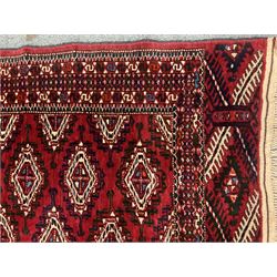 Bokhara red ground rug, repeating border, geometric patterned field
