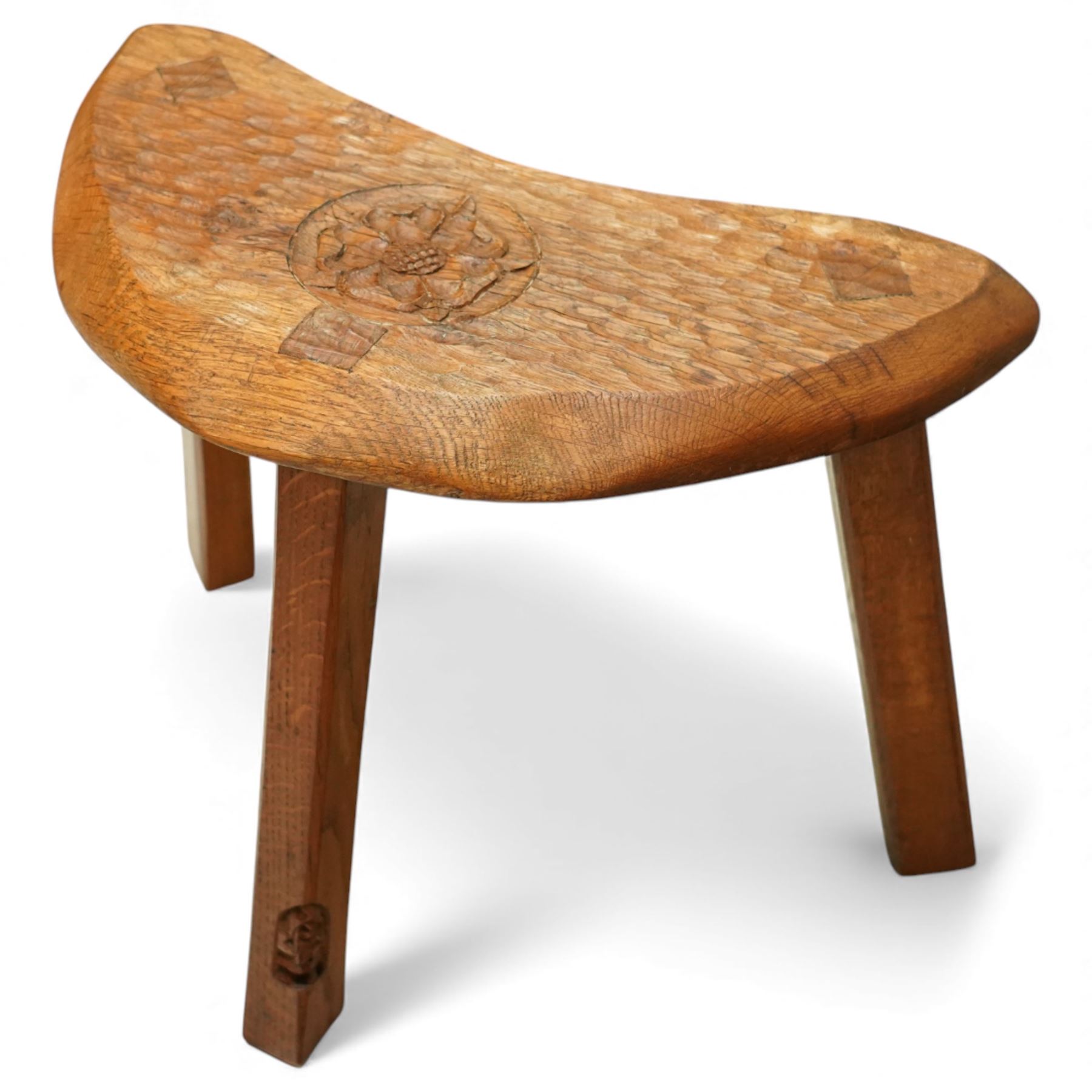 Gnomeman - oak Yorkshire rose milking stool, adzed surface with carving of a Yorkshire rose, exposed wedged through tenons, square legs with chamfered edges, with signature carving of a Gnome, by Thomas Whittaker of Littlebeck
