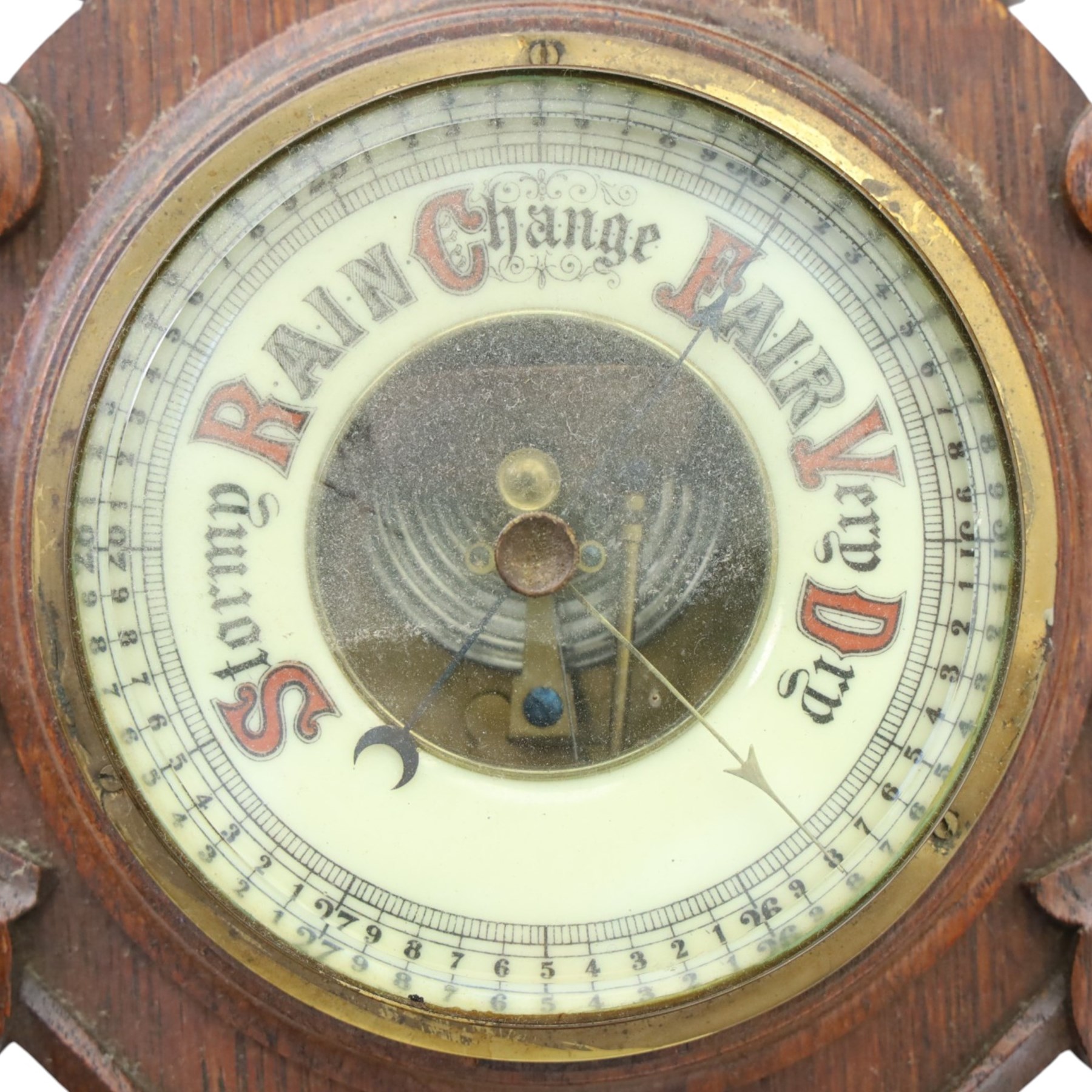 Victorian carved oak aneroid barometer, the foliate crest above a glazed thermometer, with scroll carved sides and circular dial below, H  60cm