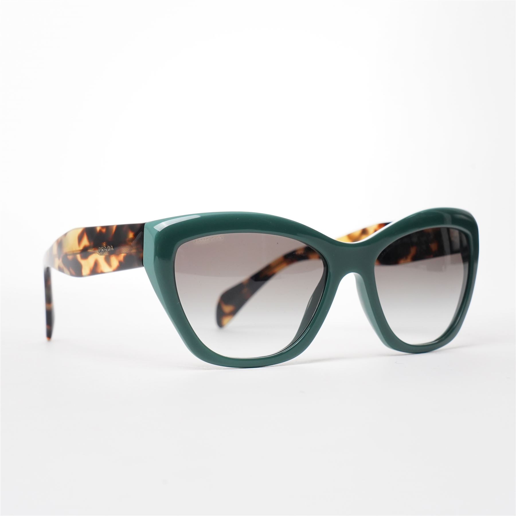 Prada - pair of cat-eye sunglasses, with green acetate frames and graduated tinted lenses, the arms in tortoiseshell finish with gold-tone ‘Prada’ branding, unused with original hard case and box