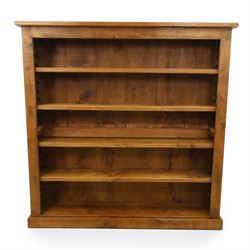 Indigo Furniture - large rustic oak open bookcase, with four adjustable shelves, above a p...