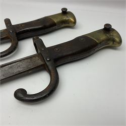 Two 19th century French model 1874 epee bayonets, each with 52cm steel blade, and armoury dates for 1880 and 1881 L64cm overall (2)