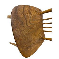 Ercol - pair of mid-20th century highback 'Windsor' chairs, curved top rail over six vertical spindles and shaped seat, on tapering cylindrical supports with stretchers