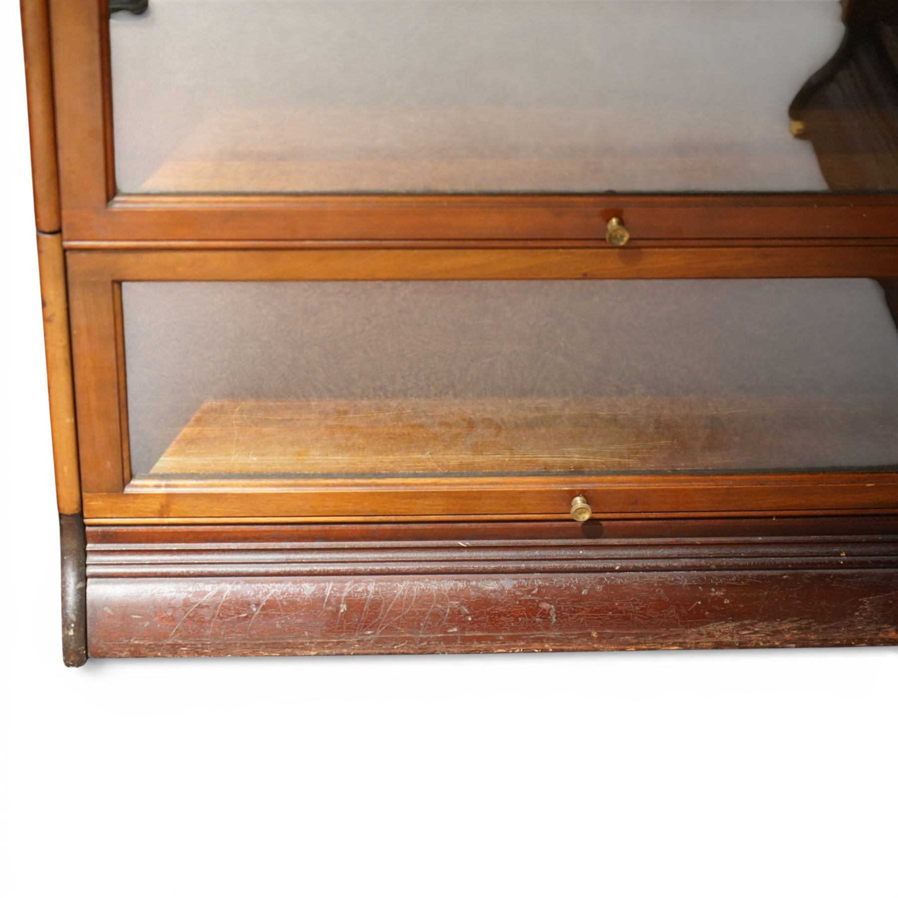 Globe Wernicke - early 20th century corner bookcase, comprising six sections, panelled sides raised on a moulded plinth base  