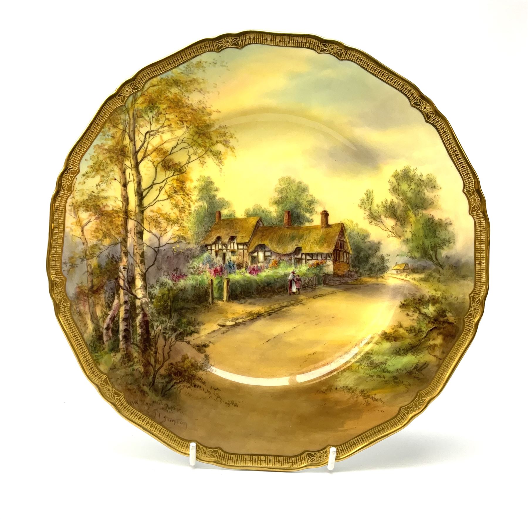 A Royal Worcester cabinet plate, decorated with and titled verso Anne Hathaway's Cottage, signed H Stinton, within a gilt rim, with black printed mark beneath, D27cm