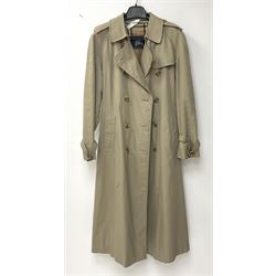 A ladies Burberry trench coat, with waist belt and check lining, no size label, measures approximately arm pit to arm pit L51cm, H117cm