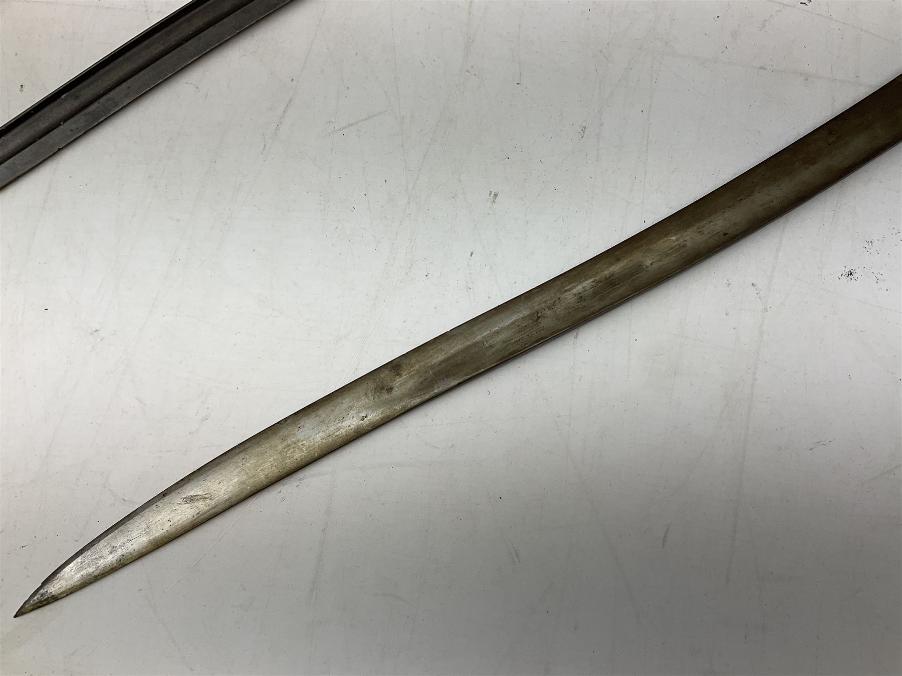 French Model 1866 sabre bayonet with 57cm fullered steel curving blade; in steel scabbard L71cm overall; another Model 1866 sabre bayonet lacking scabbard; and British Pattern 1856 sword bayonet (no scabbard) (3)