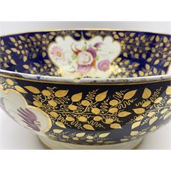 19th century continental bowl, decorated with hand painted floral sprays amongst gilt foliate decoration on a cobalt blue ground, D27.5cm
