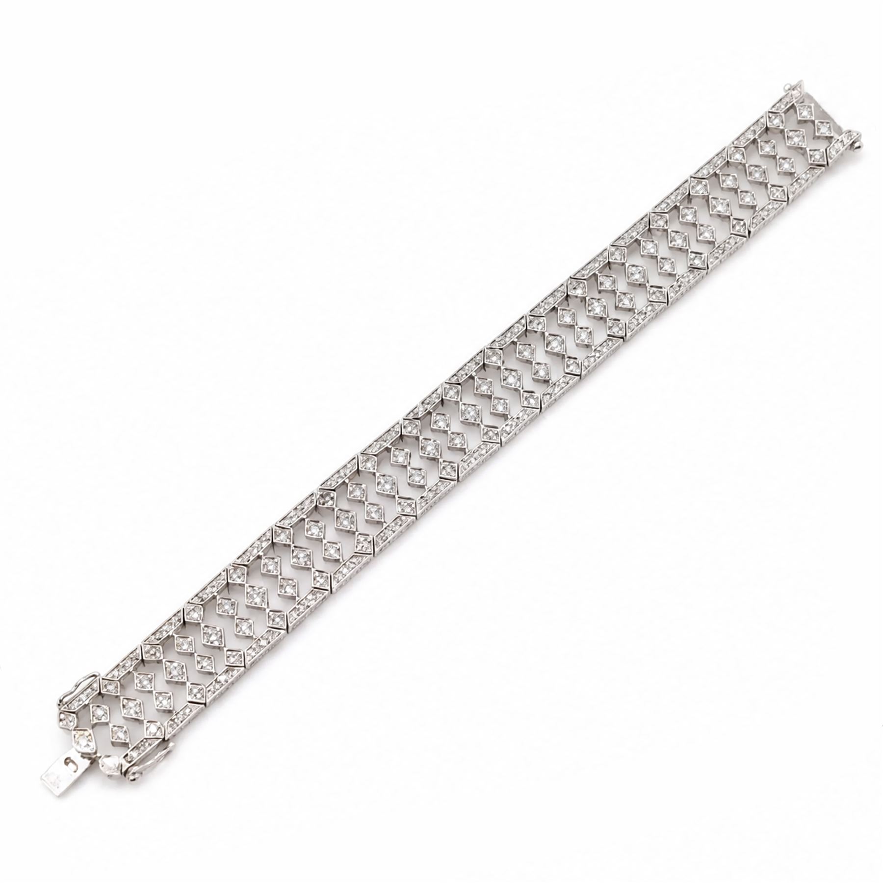 18ct white gold diamond bracelet, articulated and pierced design milgrain links set with round brilliant cut diamonds, the sides with engraved foliate decoration, stamped 750, total diamond weight approx 4.15 carat